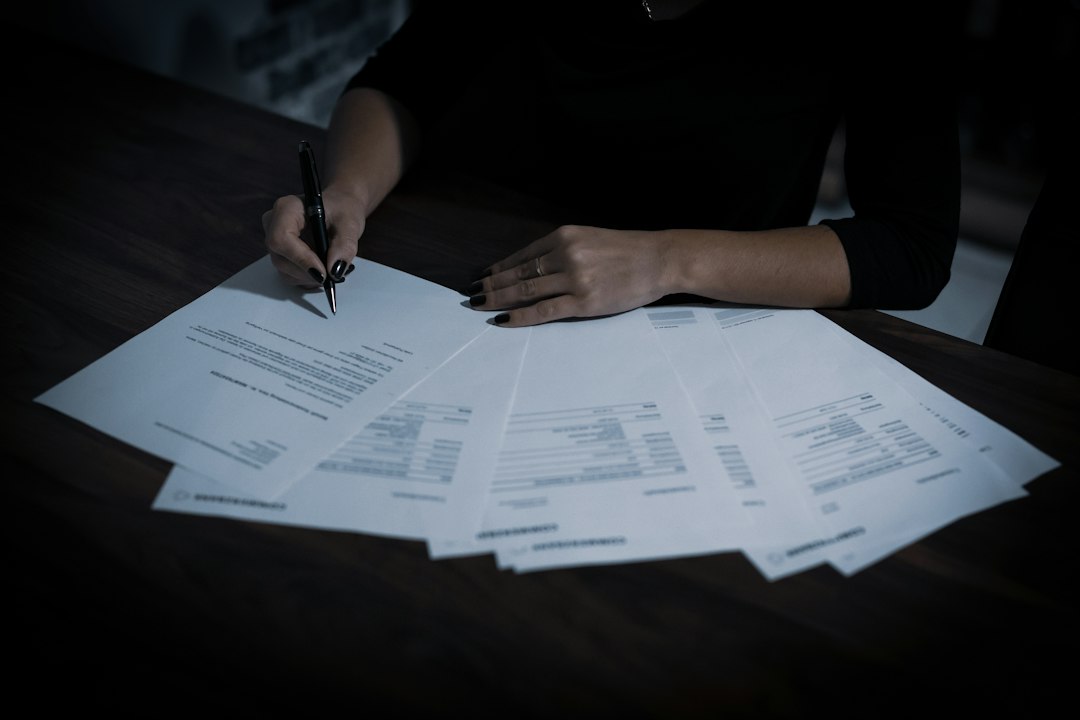 Analyst reviewing documents at a desk, illustrating through the cycle PD estimation over an economic cycle