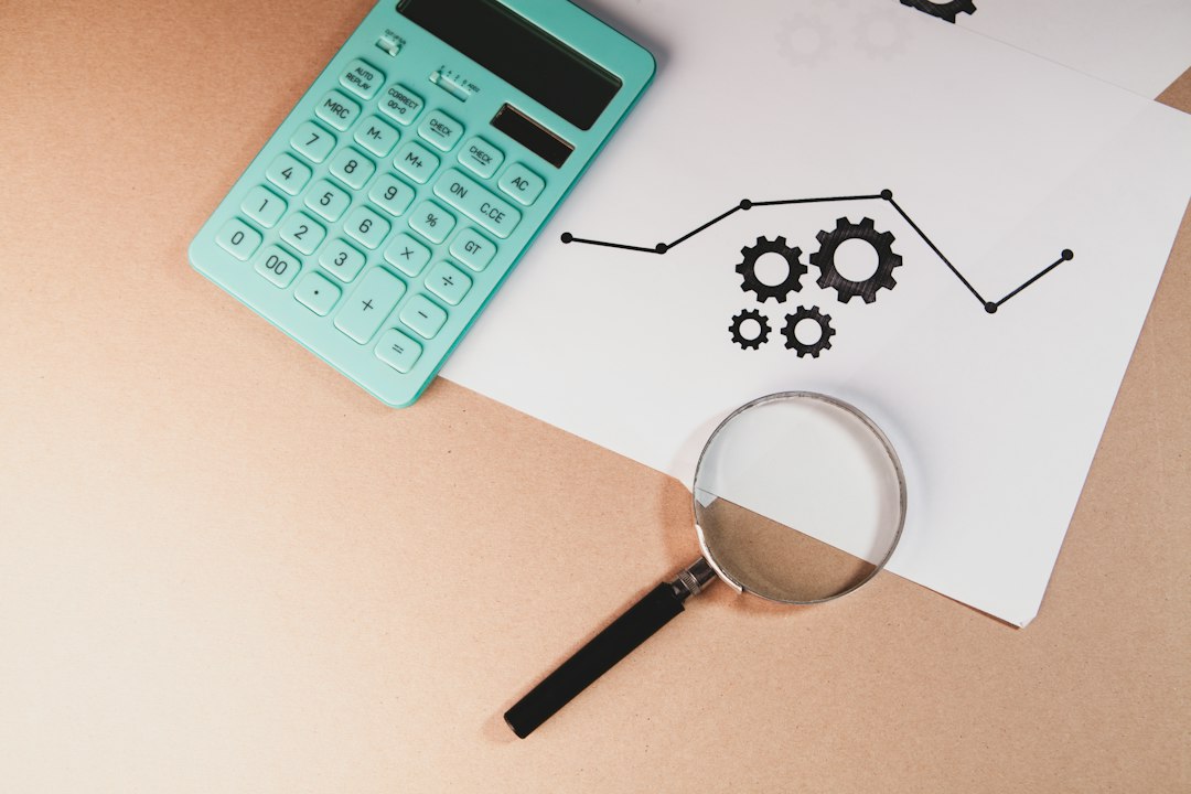 Calculator and charts on paper, illustrating IFRS 9 expected credit loss calculation at a bank